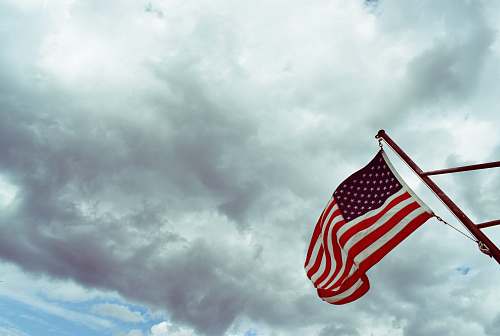 flag USA flag under white clouds symbol